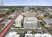Thumbnail 31 of 76 - arial view of a city with a red train on the tracks at The Icon, Richmond, VA 23230