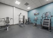 Thumbnail 44 of 76 - a large room with exercise equipment and a wall mounted tv  at The Icon, Richmond, VA 23230