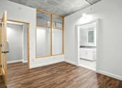 Thumbnail 45 of 71 - A room with a wooden floor and white walls.