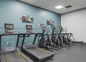 Thumbnail 63 of 76 - a room filled with cardio machines and a flat screen tv at The Icon, Richmond, VA 23230