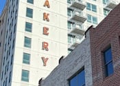 Thumbnail 6 of 18 - A tall white building with the word Bakery on it.