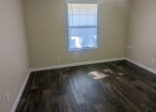 Thumbnail 22 of 28 - a bedroom with hardwood flooring and a ceiling fan
