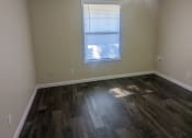 Thumbnail 18 of 33 - a bedroom with hardwood flooring and a ceiling fan