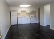 Thumbnail 15 of 33 - an empty kitchen with white cabinets and a ceiling fan