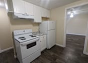Thumbnail 20 of 32 - an empty kitchen with white appliances and a refrigerator