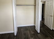 Thumbnail 27 of 32 - an empty bedroom with a closet and a hallway with a door open