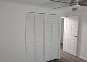 Thumbnail 25 of 25 - Closet with white doors and a ceiling fan.