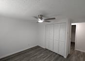 Thumbnail 19 of 25 - A room with a ceiling fan and a white closet.