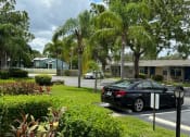 Thumbnail 9 of 21 - a black car parked in a parking lot
