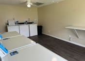 Thumbnail 21 of 21 - a kitchen with white appliances and a wood floor