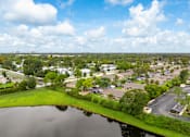 Thumbnail 2 of 24 - A lake in front of a residential area.