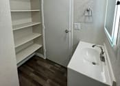 Thumbnail 14 of 43 - A small white bathroom with a sink and a mirror.