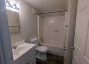 Thumbnail 11 of 16 - a bathroom with a toilet and a sink and a shower