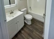 Thumbnail 7 of 43 - A white bathroom with a toilet, sink, and shower.