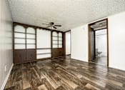 Thumbnail 42 of 43 - A room with wooden flooring and a ceiling fan.