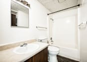 Thumbnail 38 of 43 - A white toilet sits next to a sink in a bathroom.