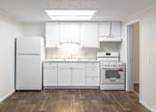Thumbnail 47 of 54 - A kitchen with white appliances and cabinets.