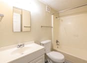 Thumbnail 50 of 54 - A bathroom with a toilet, sink, and shower.