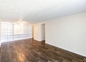 Thumbnail 43 of 54 - A room with wooden flooring and a white wall.