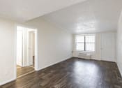 Thumbnail 44 of 54 - A room with wooden floors and white walls.