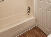 Thumbnail 14 of 33 - a bathroom with a tub and a toilet and a door