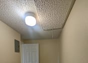 Thumbnail 23 of 32 - a hallway with a white door and wood flooring
