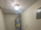 Thumbnail 28 of 32 - a room with a water heater in the corner