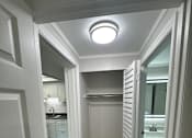 Thumbnail 9 of 32 - A white door is open to a bathroom.