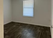 Thumbnail 32 of 33 - an empty room with a ceiling fan and a window