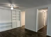 Thumbnail 26 of 33 - a living room with white shelves and a ceiling fan