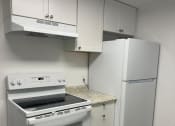 Thumbnail 19 of 22 - a kitchen with white appliances and a refrigerator