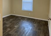Thumbnail 16 of 22 - an empty room with a ceiling fan and a window