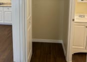 Thumbnail 14 of 22 - a walk in closet in a kitchen with white cabinets