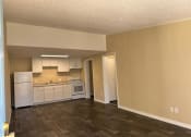 Thumbnail 17 of 22 - an empty kitchen with white appliances and a hard wood floor