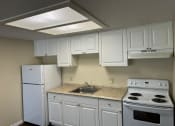 Thumbnail 13 of 22 - a kitchen with white appliances and white cabinets