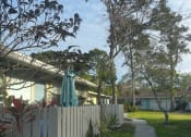 Thumbnail 5 of 22 - a sidewalk in front of a house with a white fence
