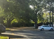 Thumbnail 4 of 22 - a white car parked in a parking lot