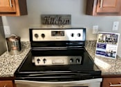 Thumbnail 5 of 14 - a kitchen with a stove and a counter top