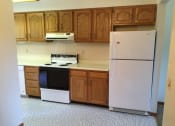 Thumbnail 9 of 17 - Appliances in the kitchen and cabinets at Dutch Hills Terrace Apartments, Parkersburg, WV