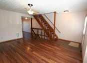 Thumbnail 18 of 21 - a living room with a staircase in a house