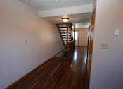Thumbnail 17 of 21 - a hallway with a wood floor and a staircase