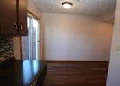 Thumbnail 15 of 21 - an empty room with wood floors and a white wall