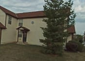 Thumbnail 7 of 18 - a white house with a red roof and a tree