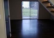 Thumbnail 9 of 11 - a empty living room with a sliding glass door