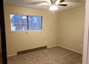 Thumbnail 5 of 11 - an empty room with a window and a ceiling fan