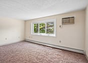 Thumbnail 29 of 44 - A room with a window and a carpeted floor.
