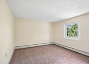 Thumbnail 39 of 44 - A room with a window and carpeted floor.