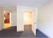 Thumbnail 5 of 16 - A room with a carpeted floor and two open doors.