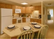 Thumbnail 10 of 16 - A kitchen with a table set for two.