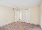 Thumbnail 24 of 44 - A room with a carpeted floor and two doors.